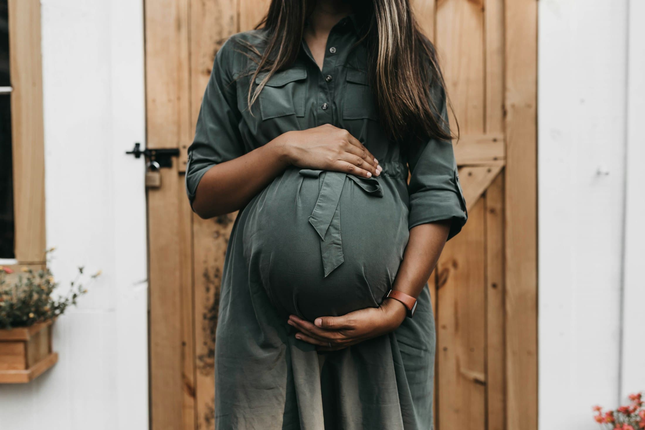 A pregnant woman holding her belly